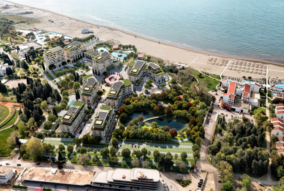 Welcome to the longest sandy beach on the Adriatic. Here, at the foot of the mountains and right by the sea, Porta Rai Beachfront Hotel & Residences offers an enhanced lifestyle and luxurious details that will forever change the way you see pleasure and relaxation. Porta Rai Beachfront Hotel & Residences is designed to have it all: It has 300 meters of private beach and spans 10 hectares. You are surrounded by almost untouched nature: a lake, a park and green oases connected by paths that lead into the central square and to a unique beach promenade. Seven pools offer everything you need to relax or unwind, as well as a mini golf course, basketball courts, tennis and padel courts, beach volleyball, children's karting and a pavilion for yoga and meditation You will always find your place. In addition to the lobby bar, there are seven restaurants, a beach club, three beach bars and a bar in the central square. Life is really celebrated here: Large public events take place in the main square, and your more intimate celebrations can be organized in the park, on the beach or by the lake. If you wish, your little ones can have fun in the playground, on the go-kart track or in the Kids Club. Porta Rai Beachfront Hotel & Residences offers you a unique experience on the beach like never before. Violet Investment, montenegro investment, karadag yatirim