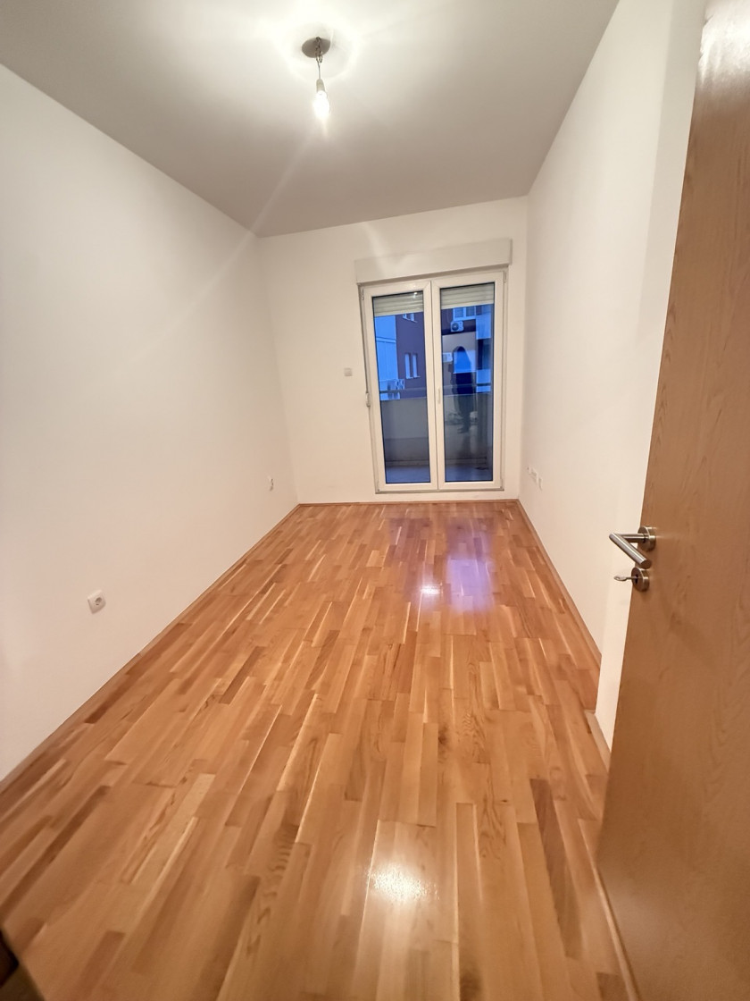 apartment for sale Podgorica, one bedroom apartment Podgorica, Ljubović apartment for sale, Aleksandra Divajna 1 Podgorica, Gradnja Promet building, 49 m2 apartment Podgorica, apartment with garage Podgorica, underground parking Podgorica, air conditioned apartment Podgorica, terrace apartment Podgorica, energy label B apartment, investment apartment Podgorica, rented apartment for sale Podgorica, quiet neighborhood Ljubović, near Capital Plaza Podgorica, near Delta City Podgorica, nekretnine Podgorica prodaja, jednosoban stan Ljubović, stan sa garažnim mjestom Podgorica, stan u novijoj zgradi Podgorica