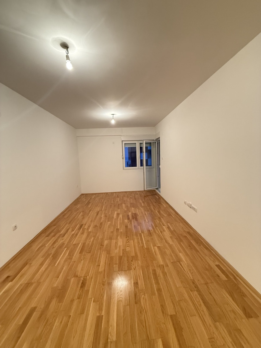 apartment for sale Podgorica, one bedroom apartment Podgorica, Ljubović apartment for sale, Aleksandra Divajna 1 Podgorica, Gradnja Promet building, 49 m2 apartment Podgorica, apartment with garage Podgorica, underground parking Podgorica, air conditioned apartment Podgorica, terrace apartment Podgorica, energy label B apartment, investment apartment Podgorica, rented apartment for sale Podgorica, quiet neighborhood Ljubović, near Capital Plaza Podgorica, near Delta City Podgorica, nekretnine Podgorica prodaja, jednosoban stan Ljubović, stan sa garažnim mjestom Podgorica, stan u novijoj zgradi Podgorica