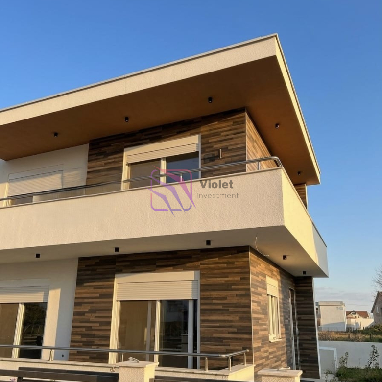 A modern family house for sale in Štoj, Ulcinj, offering the perfect balance of comfort, functionality, and privacy. With a total living area of 168 m² and a 250 m² landscaped yard, this property is ideal for family living, holiday use, or investment near the Adriatic coast. Located in a quiet residential area, the house is only a few minutes’ drive from the beach, providing a relaxed Mediterranean lifestyle. Property Overview Living area: 168 m² Land area: 250 m² Bedrooms: 4 Bathrooms: 2 Floors: 2 levels connected by internal staircase Parking: Covered parking for 2 vehicles Condition: Modern, fully equipped Location: Quiet neighborhood near the beach Interior Layout The house is carefully designed for comfortable family living, including: Spacious living room with kitchen and dining area Four bedrooms Two bathrooms Laundry room with new washing machine Functional layout with good separation of living and sleeping areas Features & Equipment Fully equipped modern kitchen with appliances Complete air conditioning system Travertine wall finishes Lowered ceilings with LED lighting High-quality materials and contemporary design Bright and comfortable interior spaces Outdoor Area 250 m² landscaped yard Outdoor and indoor lighting system Covered parking for 2 vehicles Possibility to build a swimming pool without reducing parking or green areas Location Štoj is a peaceful residential area near Ulcinj, known for: Long sandy beaches Natural surroundings and privacy Relaxed coastal atmosphere Increasing demand for residential properties The property is only a few minutes’ drive from the sea and local amenities. Investment Potential This property offers strong potential for: Permanent family residence Holiday home near the coast Rental investment during tourist season Future value increase due to location development FAQ — House in Štoj (168 m²) 1) What is for sale? A modern two-level family house of 168 m² in Štoj, Ulcinj. 2) How many bedrooms and bathrooms does the house have? The house includes 4 bedrooms and 2 bathrooms. 3) Does the property have parking? Yes, it includes covered parking for 2 vehicles. 4) Is the house furnished? The house is equipped with modern kitchen and appliances. 5) Is air conditioning installed? Yes, the property has complete air conditioning. 6) Can a swimming pool be built? Yes, the plot layout allows construction of a pool without affecting parking or yard space. 7) Is the location quiet? Yes, the property is located in a peaceful residential area. 8) How far is the beach? The beach is only a few minutes’ drive away. 9) Is the property suitable for investment? Yes, it is ideal for holiday rental or long-term value. 10) Who is this property ideal for? Ideal for families, investors, or buyers seeking a modern home near the sea, violet investment